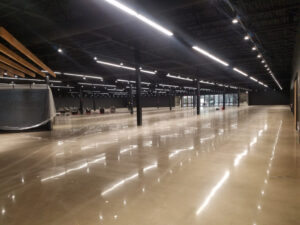 a beautiful polished concrete flooring reflecting overhead light and shining