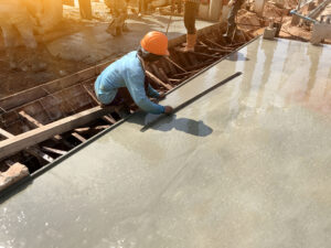 a professional from Concrete Etc smoothing out a custom polished concrete floor